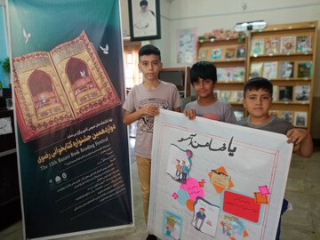 ساخت روزنامه دیواری جشنواره کتابخوانی رضوی در کتابخانه روستایی اشتهارد